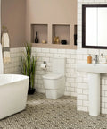 Espresso Medicine Cabinet With Mirrored Doors 24 Inch Wide Wall Mount Bathroom Cabinet above a white pedestal sink and toilet