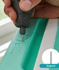 Using Top Notch Variable Speed Rotary Tool Kit With Badass One Point Six Amp Motor Dialing Up To Thirty Five Thousand Rpm to engrave a green surface.