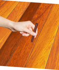 Hand using Dark Brown Wood Repair Kit Wax Filler Sticks For Floors Cabinets And Surfaces Easy To Use No Mess Scratch Repair