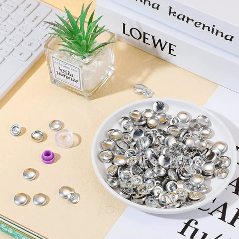 100 Pack DIY Button Kit With Wire Backs And Tools displayed in a dish, fabric buttons size 24 for clothes and crafts.