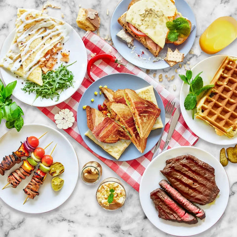 Aigostar 3 In 1 Electric Sandwich Maker With Removable Nonstick Plates Panini Press Grill And Waffle Iron 750W meal spread with sandwiches and waffles.