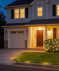 House exterior with 100 LED Warm White Christmas String Lights With 35 Ft White Wire decorating front bushes, creating cozy vibes