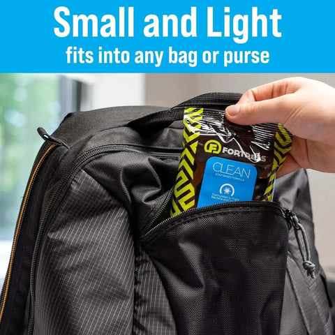 Person placing To Go Tech Wipes 25 Count in backpack, emphasizing travel size convenience for cleaning electronics.