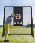 Golfer practicing with 10x10 Golf Hitting Net With Side Barriers And Ball Return System For Indoor Practice on grass field.