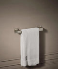 Honesty 12-Inch Towel Bar in Vibrant Brushed Nickel Finish with white towel, modern stainless steel bathroom accessory