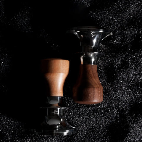 Heavy Duty Stainless Steel Coffee Tamper With Flat Base And Adjustable Fit Options For Pro Level Baristas And Home Packers Solid Espresso Powder Compacting Tool In Sleek Gray shown from above on dark surface.