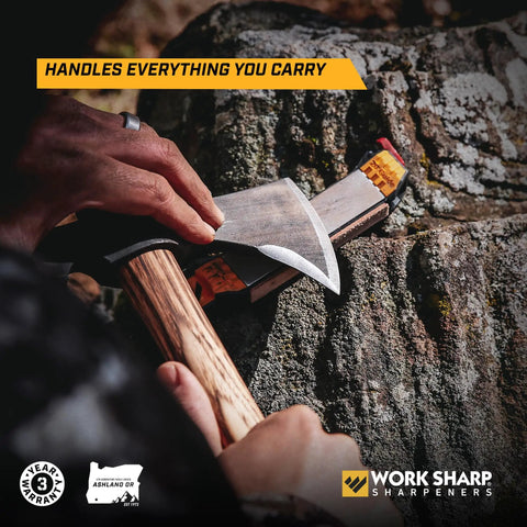 Roam Ready Guided Field Sharpener With Diamond Guides And Adjustable Wrench giving blade care on an axe outdoors.