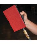 Top Shelf Pneumatic Orbital Sander With Built In Air Regulator And Rubber Over Mold Grip held in hand, showing sanding block detail.