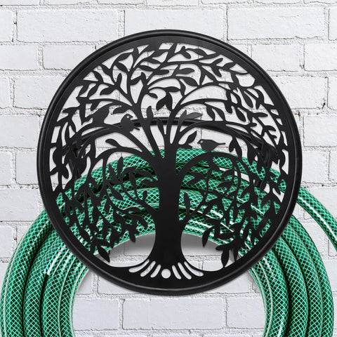 Heavy Duty Outdoor Garden Hose Reel and Wall Mount Holder With Tree of Life Metal Design on brick wall with green hose
