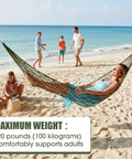 Woman relaxing in 4 Pack Mesh Hammocks Set For Outdoor Chill Pine Green Nylon Hammocks 98.4 x 31.5 Inches on a beach.