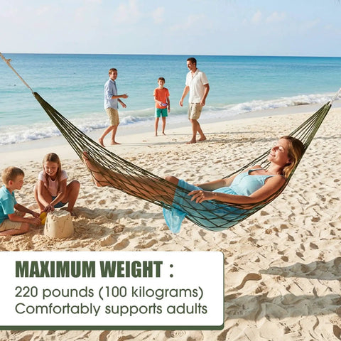 Woman relaxing in 4 Pack Mesh Hammocks Set For Outdoor Chill Pine Green Nylon Hammocks 98.4 x 31.5 Inches on a beach.