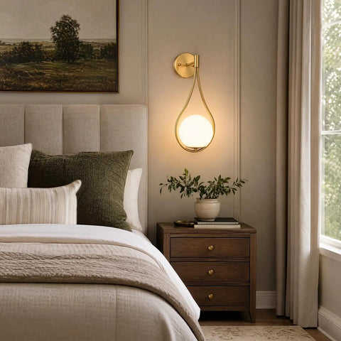 Lit Mid Century Modern Wall Sconces Set Of 2 With Globe Glass Shades In Antique Brass Finish in bedroom setting