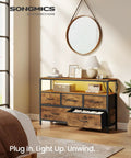 App Controlled Led Dresser With Charging Station And Five Drawer Chest Tv Stand Industrial Rustic Brown Ink Black Bedroom Furniture For Your Major Bedroom Glow Up in a stylish bedroom setting.