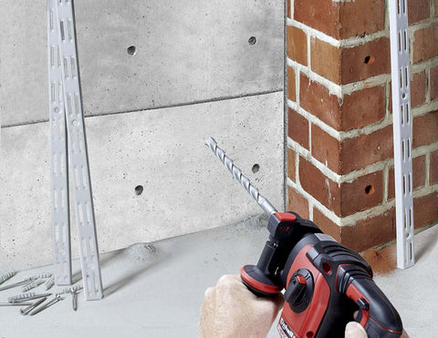 Front view of red cordless hammer drill with 5/32-in SDS-Plus carbide bit; ten masonry drill bits on floor.