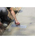 Worker using QLT Concrete Finishing Trowel With Soft Grip Handle For A Smooth Cement Finish on wet concrete surface