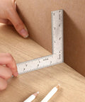 Real Deal Stainless Steel L Square Framing Ruler 4 By 6 Inch 90 Degree Layout Tool used for precise measurements on wood.