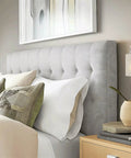 Kira Home Phoebe 8" Modern Industrial Wall Sconce for Bathroom Vanity, Pack of 2 mounted beside grey tufted headboard.