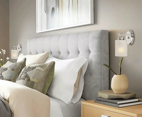 Kira Home Phoebe 8" Modern Industrial Wall Sconce for Bathroom Vanity, Pack of 2 mounted beside grey tufted headboard.