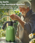 Hand Pump Sprayer 2L Garden Sprayer For Plants And Lawn Care side refill being used by a person in a garden setting