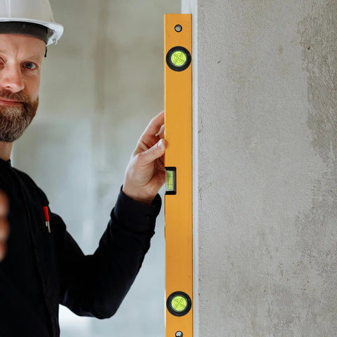 4pcs Acrylic Cylindrical Mini Spirit Level Tool for Precise Measuring used by a worker to check wall level with a yellow level.