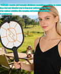 Woman holding Two Pack Electric Fly Swatter Racket Set, AA Battery Powered Bug Zapper for Indoor Outdoor Use, in garden setting