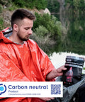 Man wearing orange poncho with package of 4 Pack Emergency Survival Foil Poncho Reversible Thermal Mylar Orange Heat Retention Up To 92 Percent Lightweight Portable Grab And Go Double Sided Rain Gear For Outdoors Camping Hiking And Emergencies