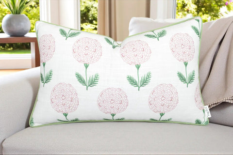 Pink Block Print Marigold Lumbar Pillow Cover 12x20 off-white slub cover with pink floral print and green piping on sofa