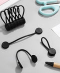 Slick Magnetic Silicone Cable Ties 10 Pack Reusable Cord Organizer for Laptops Phones Travel Gear on desk with scissors and pencil.