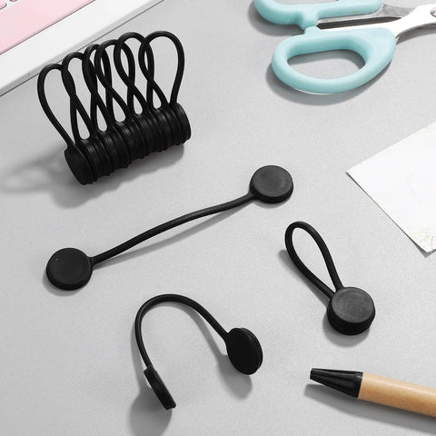 Slick Magnetic Silicone Cable Ties 10 Pack Reusable Cord Organizer for Laptops Phones Travel Gear on desk with scissors and pencil.