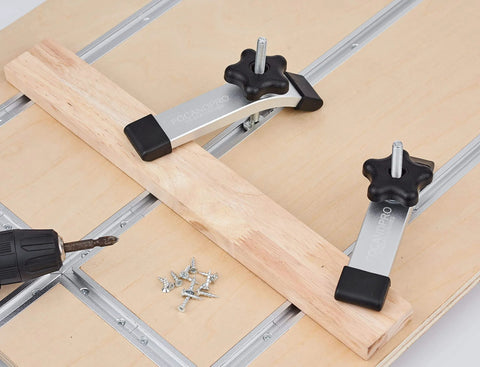 36-Inch Aluminum T Track With Wood Screws, Double-Cut Profile, Predrilled Mounting Holes, Fine Sandblast Anodized Silver Finish, 2-Pack For Woodworking And Clamps, Fits 5/16-Inch T-Bolts And Hold-Down Clamps, Heavy-Duty 6063 Aluminum installed on wood with clamps.