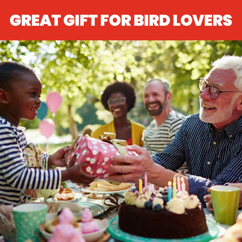 Group of people celebrating outdoors with gifts and cakes as a great gift for bird lovers sign is displayed.