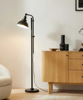 Industrial Floor Lamp With 180 Degree Adjustable Head, Lit LED Reading Light next to a wooden cabinet in a living room