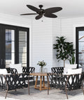 Duval 52 Inch Indoor Outdoor Ceiling Fan With Hand Carved Basswood Blades, Bronze Finish, installed on a patio ceiling