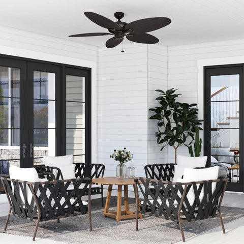 Duval 52 Inch Indoor Outdoor Ceiling Fan With Hand Carved Basswood Blades, Bronze Finish, installed on a patio ceiling
