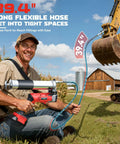 Man using Cordless Grease Gun For Milwaukee 18V Batteries, 12000 PSI High Pressure with 39.4 inch hose near construction equipment