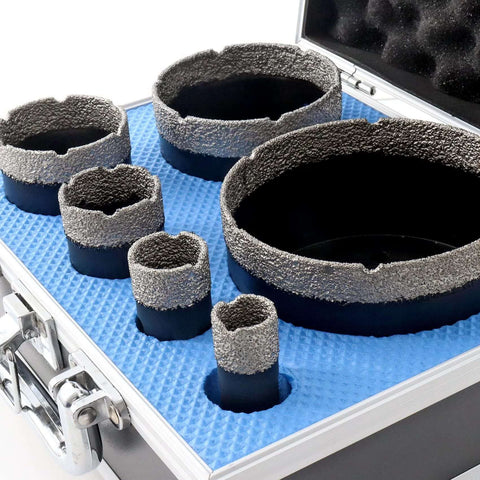 Top-down view of a six-piece diamond core drill bit set in a blue foam-lined case