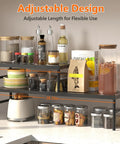 Hella Adjustable And Stackable Kitchen Cabinet Organizer with spices, jars, and bottles on a 16.4in to 28.35in adjustable metal shelf.