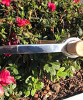 All Purpose Garden Pick Mattock Hoe With Wooden Handle 15.7 Inch Forged Adze Pick used in flower bed with pink flowers
