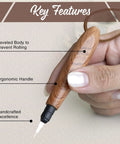 Close-up of ergonomic wooden needle threader with extended stainless hook, showing handle and features for hand sewing.