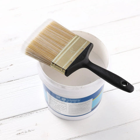 4 Inch Soft Tip Paint Brush For Walls And Trim With Pro Grade Synthetic Bristles next to a paint can on a wooden surface
