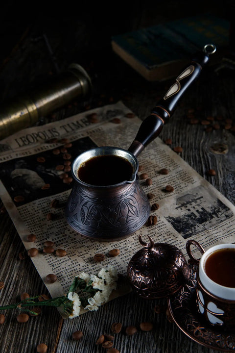 Thick Copper Turkish Coffee Pot Cezve Ibrik Briki With Wooden Handle And Hand Engraving Antique Copper Finish 9 Ounce Stovetop Coffee Maker For Gas And Electric Not Induction Handmade In Turkey on rustic table with coffee beans