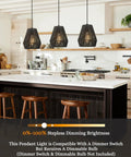 Three 7 Inch Handwoven Rattan Pendant Lights With Matte Black Basket Shades above a modern kitchen island.