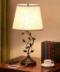 Vintage Tree Branch Base Table Lamp With Beige Shade USB A And USB C Charging Ports Tall Bedroom End Table Lamp For Bedside Or Living Room Retro Yet Modern Look That Elevates Any Decor on a wooden table with books and cup