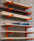 Heavy Duty Wall Mounted Lumber Rack Go Big Or Go Home Holds Over A Ton installed on wall with organized wood and tools in garage.