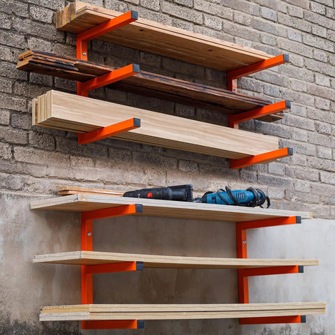 Heavy Duty Wall Mounted Lumber Rack Go Big Or Go Home Holds Over A Ton installed on wall with organized wood and tools in garage.