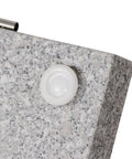 Close-up of Heavy Duty Granite Patio Umbrella Base With Handle And 2 Casters, detailed view of caster on grey stone surface.
