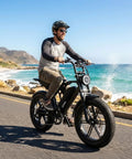 Man riding All Terrain Electric Bike For Adults With 1500W Peak Motor 48V 15Ah Battery 60 Mile Range by the beach
