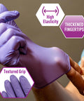 Person demonstrating high elasticity and textured grip of Powder Free Nitrile Exam Gloves Iris Blue Medium Box Of 100 For Medical Labs Hospitals And Professional Use With Textured Fingertips For Superior Tactile Sensitivity Durable Stretchable Puncture Resistance Latex Free.
