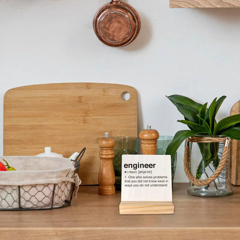 Engineer Definition Wood Plaque Sign Gift For Engineers Office Decor Desk Display on kitchen counter with plants and jars.
