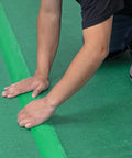 Person installing Straight Up Heavy Duty Underlayment Pad For Laminate And Engineered Wood Floors Featuring Gnarly Moisture Shield.